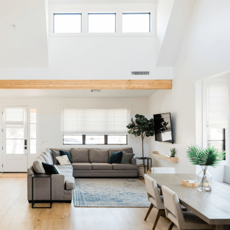 A contemporary living room with a spacious skylight, illuminating the room with natural light.