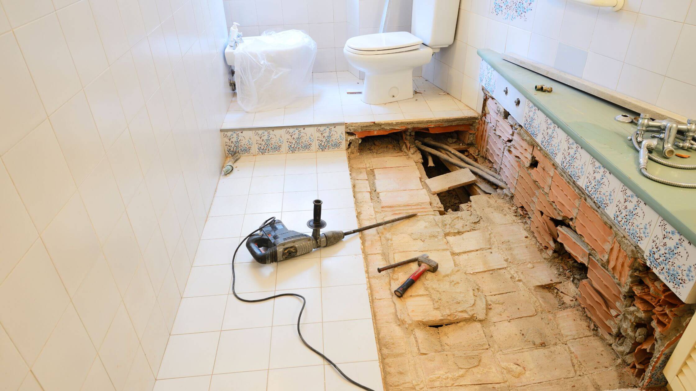 A bathroom remodel featuring a toilet, sink, and shower.
