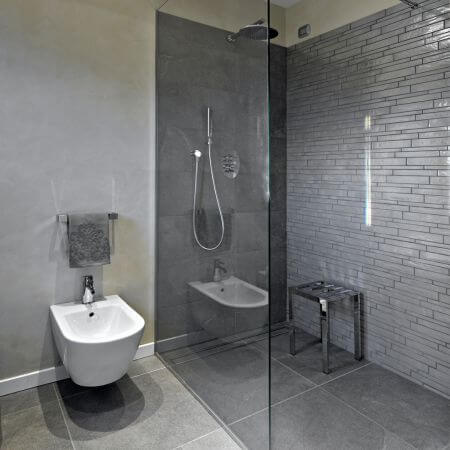 Bathroom-Conversion-3 A sleek modern bathroom featuring a glass shower stall and modern fixtures.