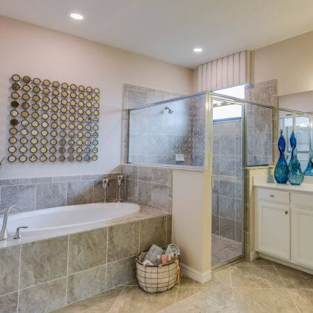 A spacious bathroom featuring a walk-in shower and a relaxing bathtub.